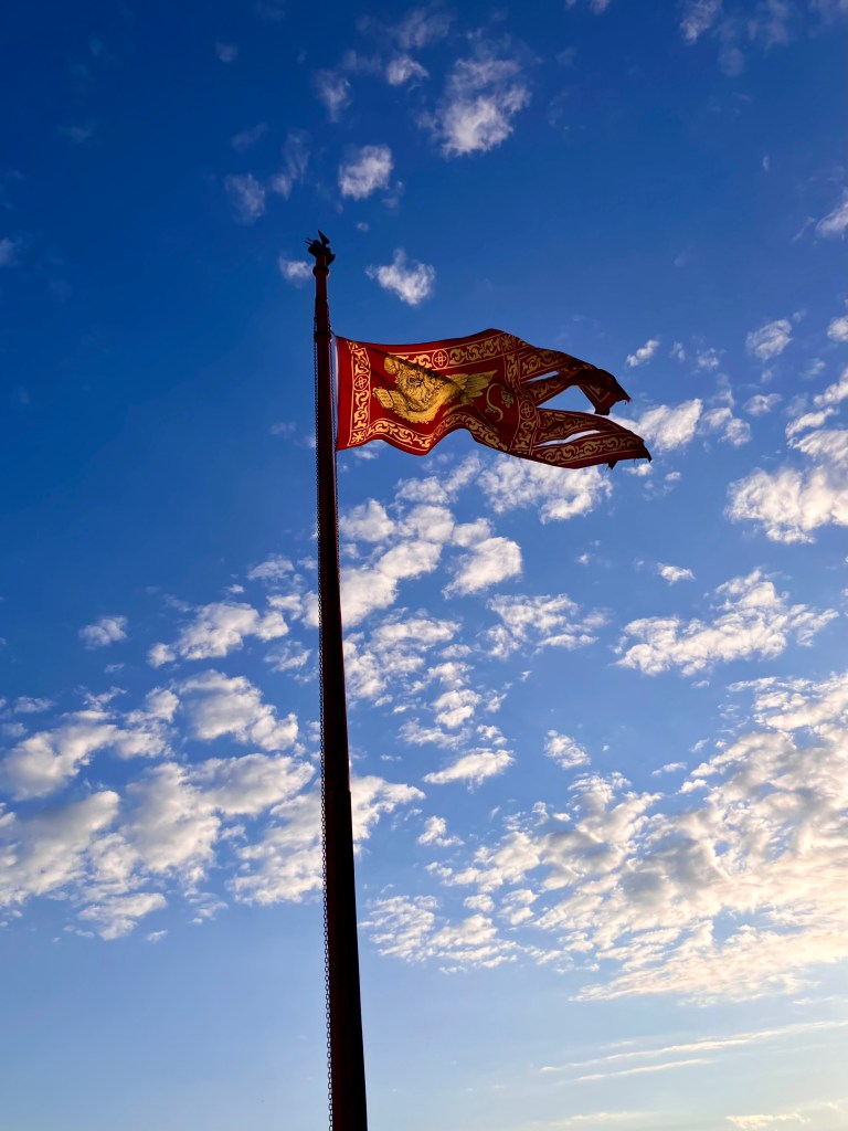 The flag of the Venetian republic against a blue sky