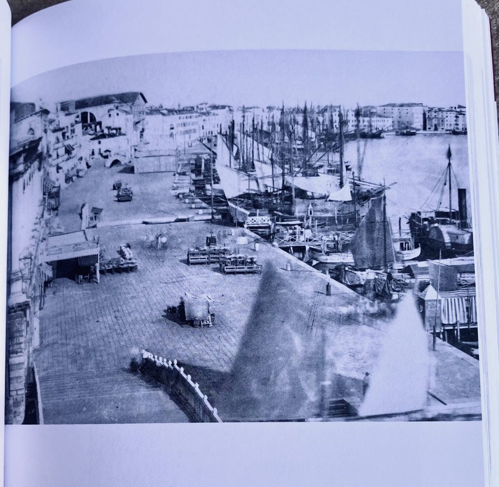 Black and white photo. Many sailboats moored along the Riva degli Schiavoni in 1869 