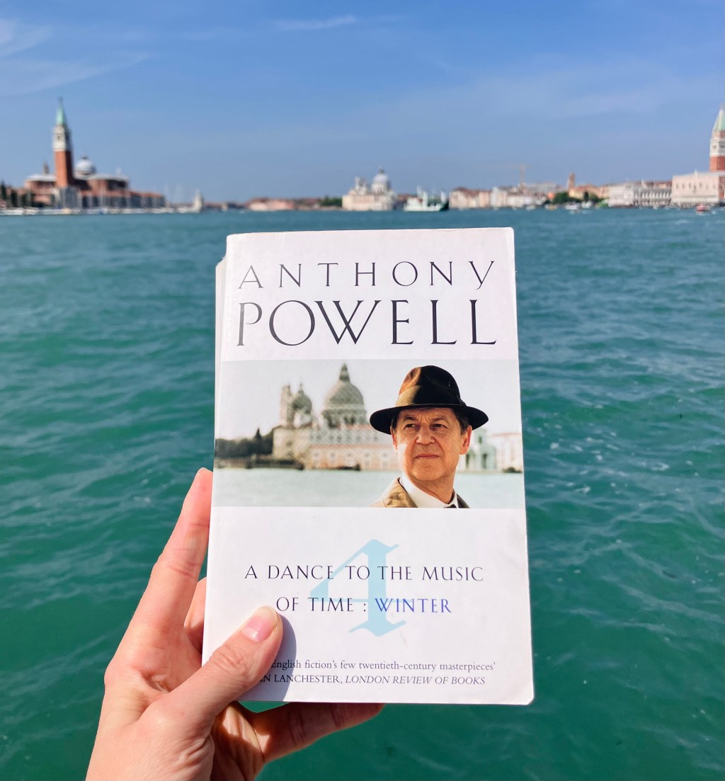 Vol 4 of A Dance to the Music of Time, held in front of the San Marco basin, with Santa Maria della Salute right behind the book —this church is featured on the book's cover